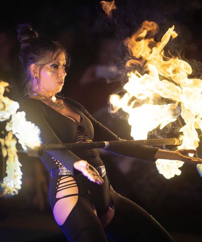 Jessica Cooper performing with fire props